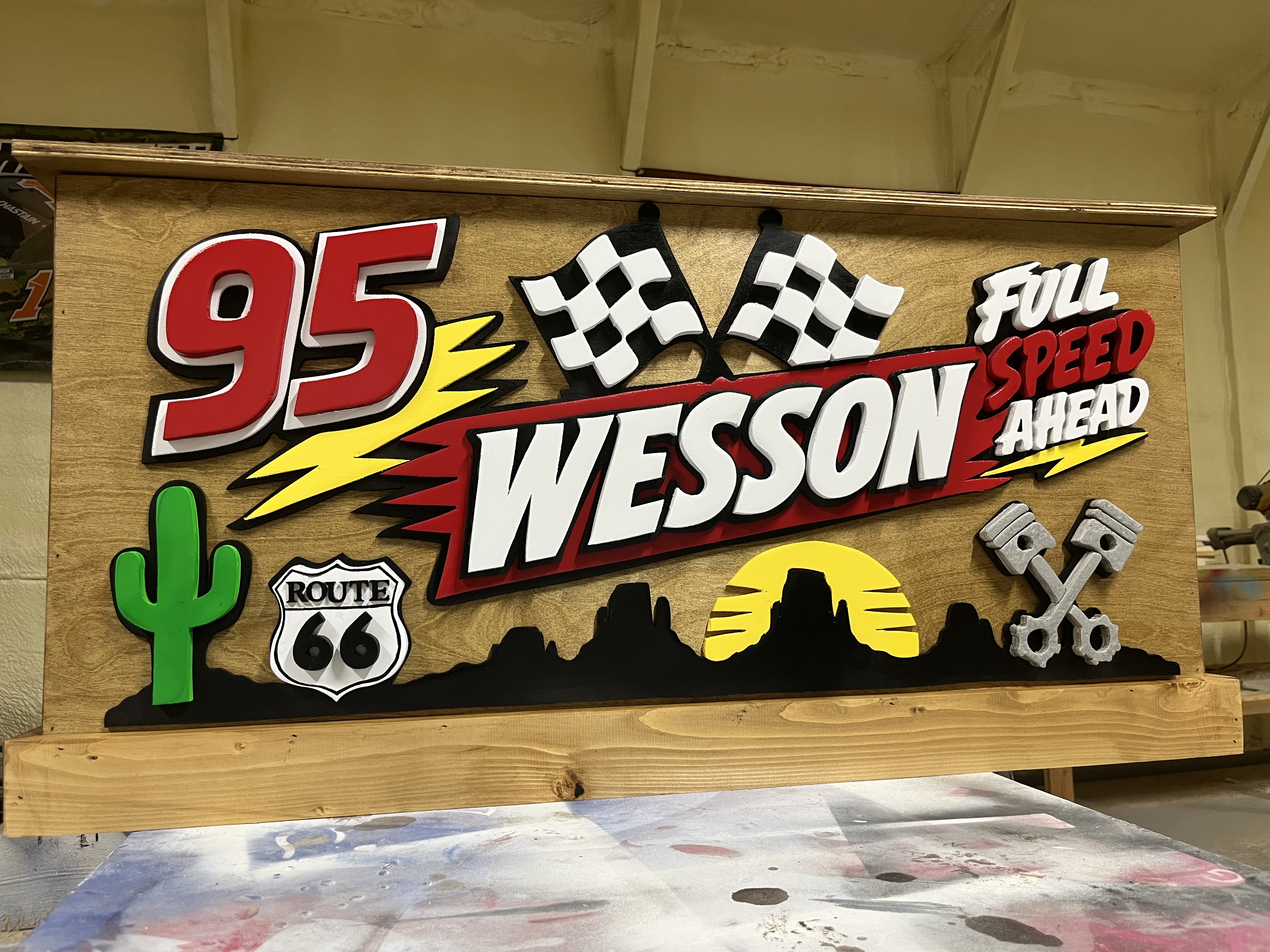 Racing themed wooden toy box with a hand-cut car and checkered flag