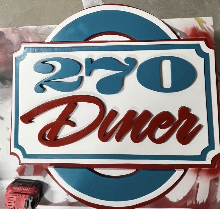 Hand-cut diner sign hanging in the restaurant it was built for