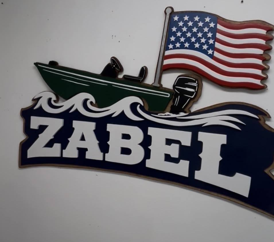 Family name sign with a hand-cut boat, hung in a customer's home